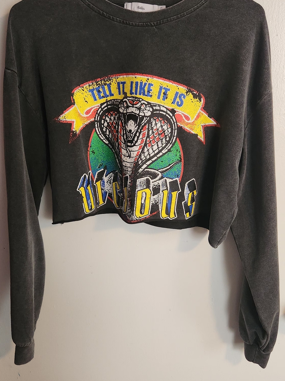 Adika Black Cropped Sweatshirt with Cobra Graphic and Yellow Banner